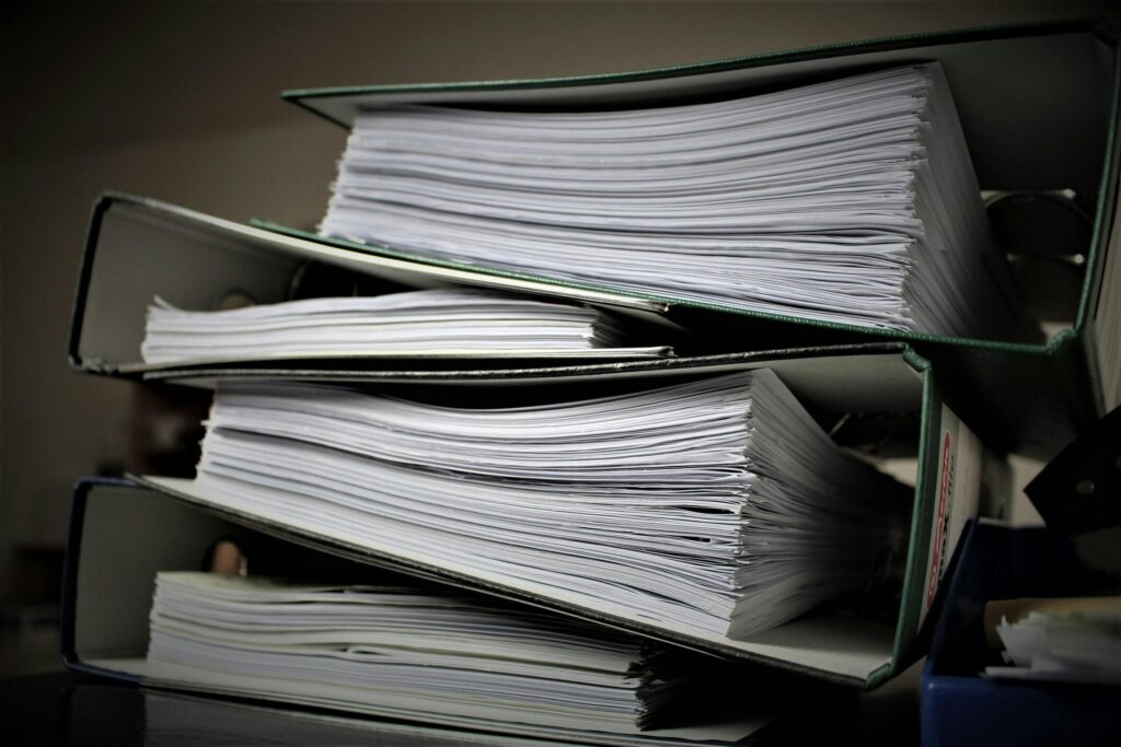 pexels photo 357514 357514 Close-up of stacked binders filled with documents for office or educational use.